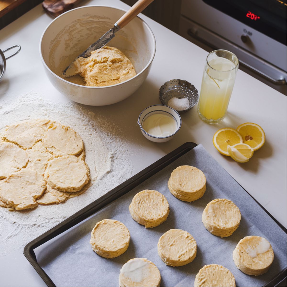 Scone dough and tray on a floured countertop.