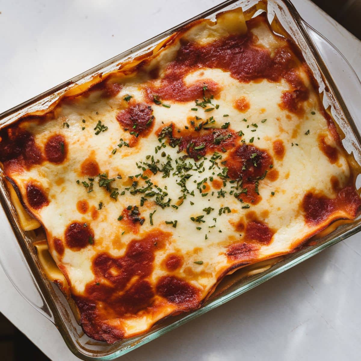 Baked chicken lasagna with golden cheese.