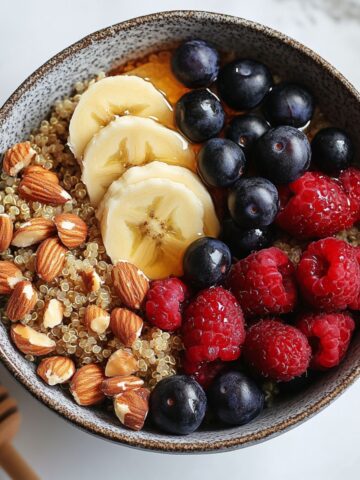 Homemade Quinoa Breakfast Bowl topped with fresh fruits and nuts