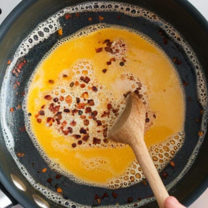 Chili butter with Aleppo pepper cooking in a pan
