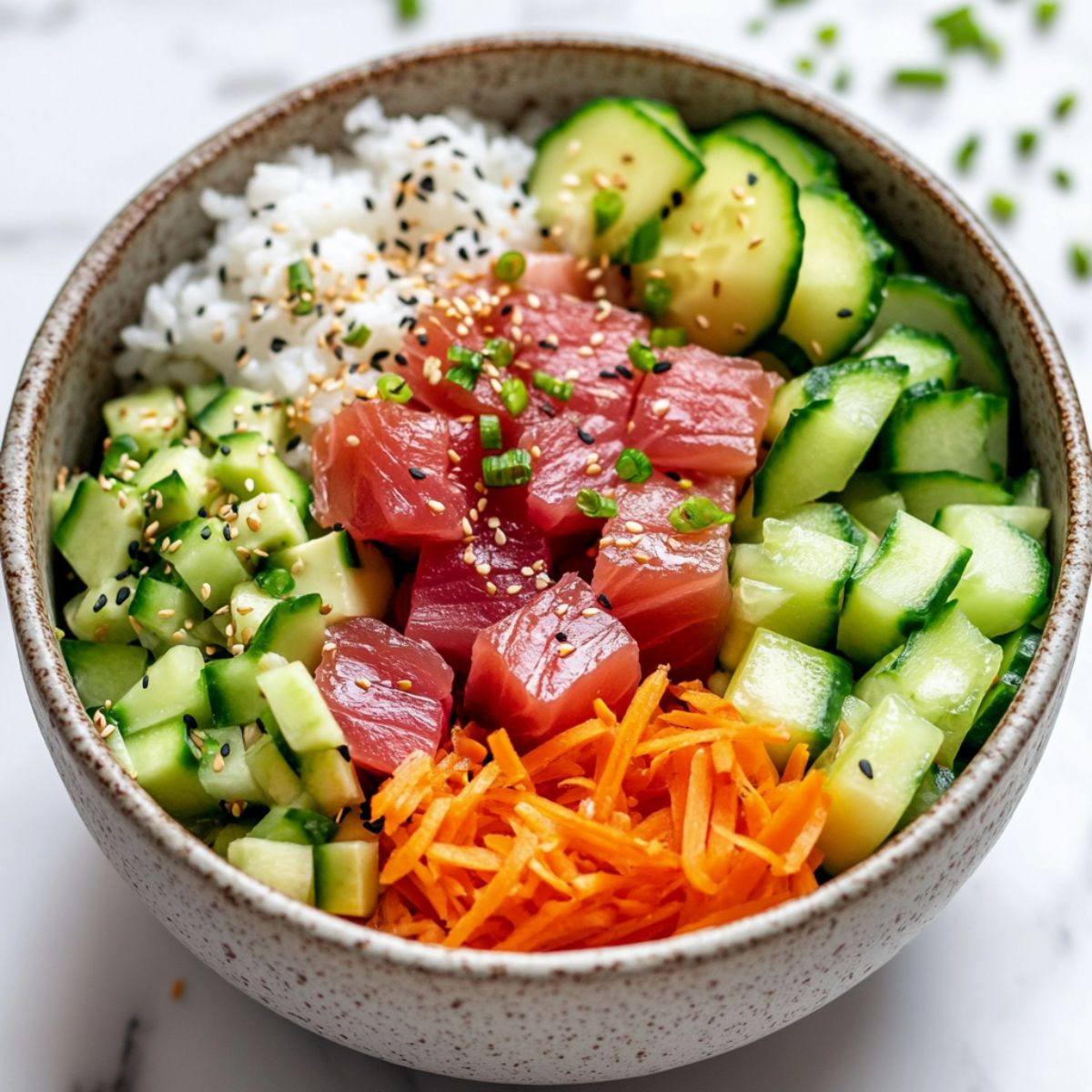 Homemade tuna poke bowl recipe with fresh ingredients on a clean white marble kitchen counter.