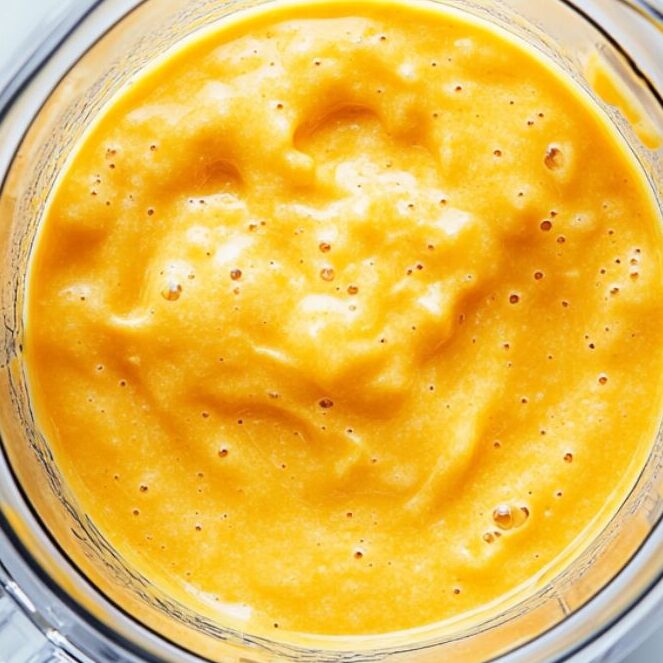 Blending orange smoothie until smooth