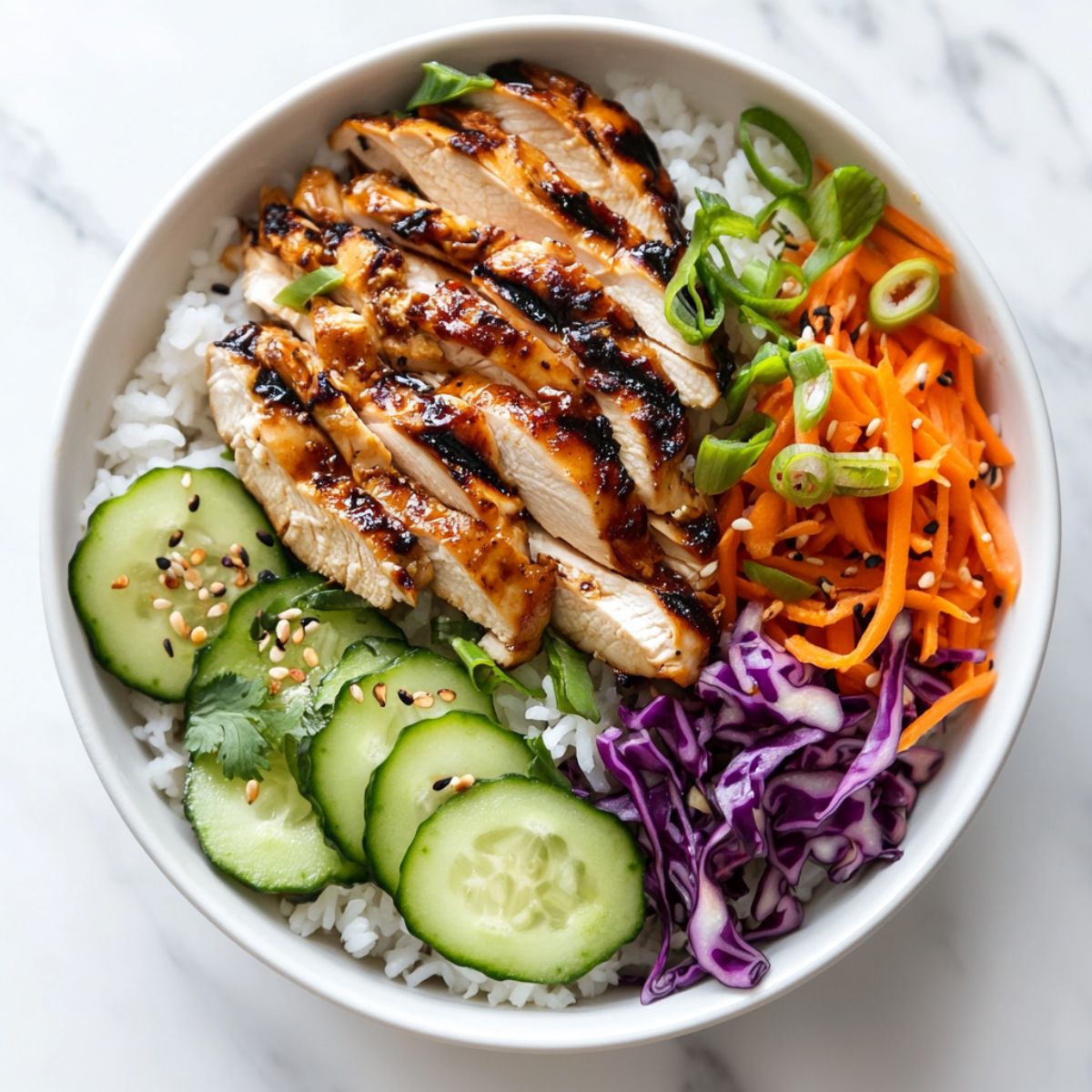 Chicken rice bowl recipe with marinated grilled chicken and colorful vegetables on jasmine rice