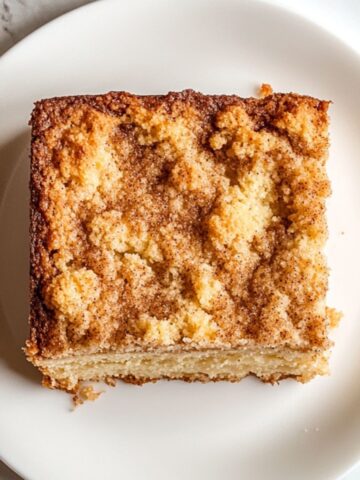 Homemade coffee cake recipe with a crumb topping and a slice served with coffee