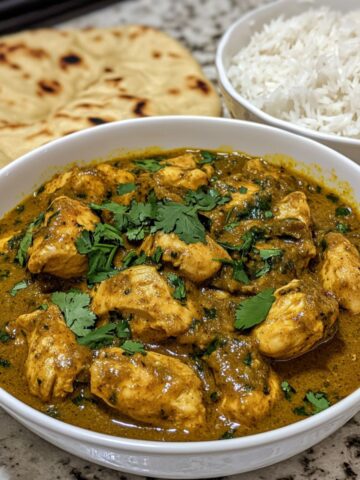 Delicious homemade chicken curry served with naan and rice."