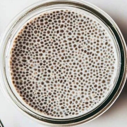 Chia pudding resting in a jar after the first stir