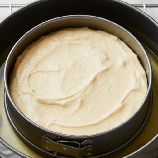 Cheesecake pan in water bath setup inside oven, top view