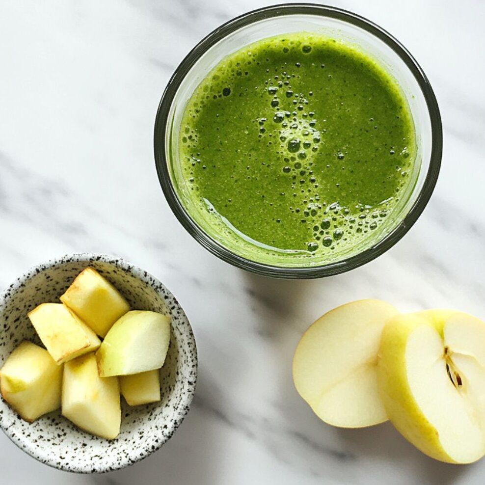 Green Detox Smoothie with extra add-ins on marble counter.