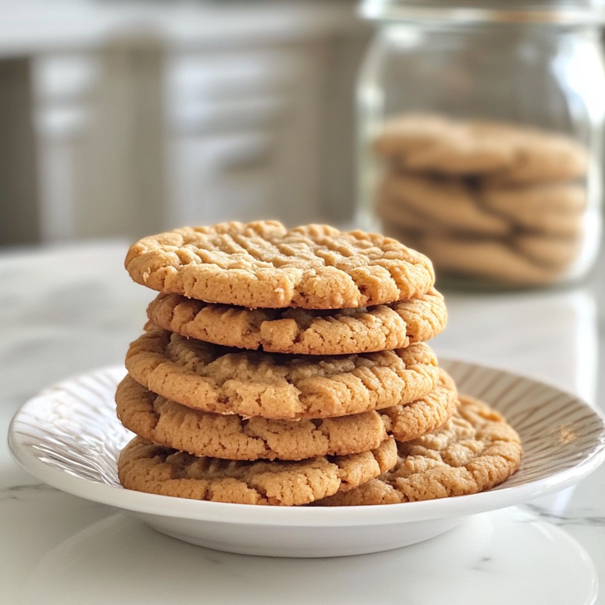 Freshly baked peanut butter cookies recipe  cooling on a white marble kitchen counter