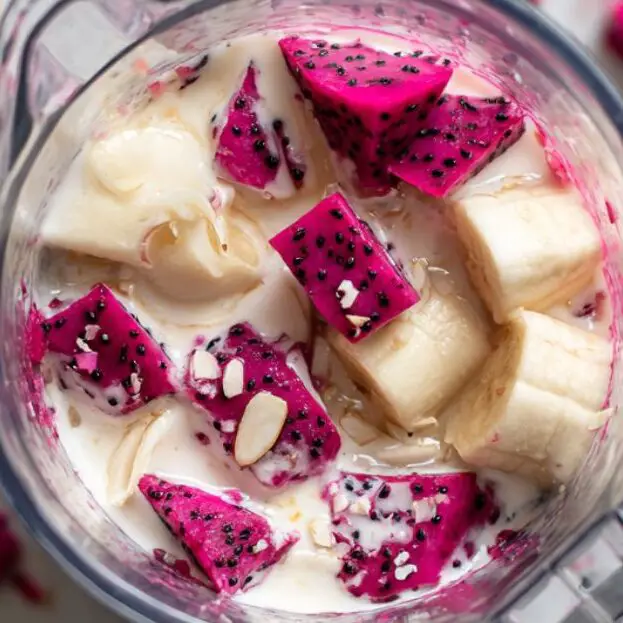 Overhead view of a blender with smoothie base ingredients inside