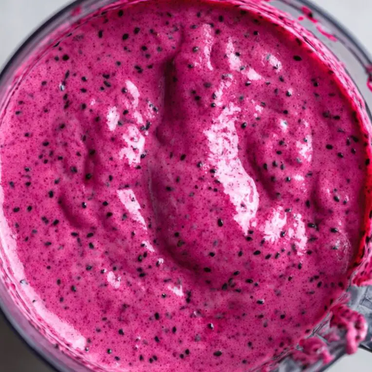 Thick pink dragon fruit smoothie inside a blender jar