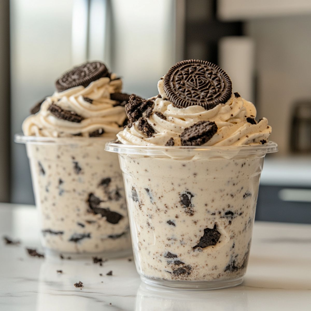 Oreo Pudding Recipe  dessert served in a clear dish with visible creamy layers and crushed Oreos.