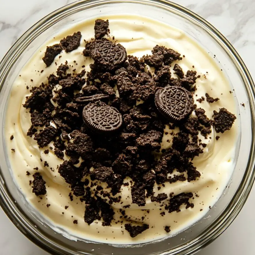 Oreo pudding served in clear cups with crushed Oreo topping, ready to chill.