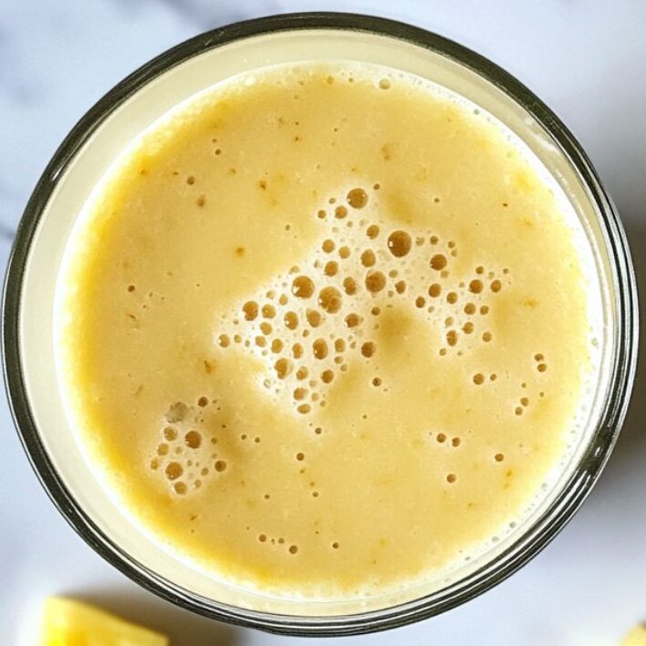 Served pineapple smoothie with chunks of pineapple on the side