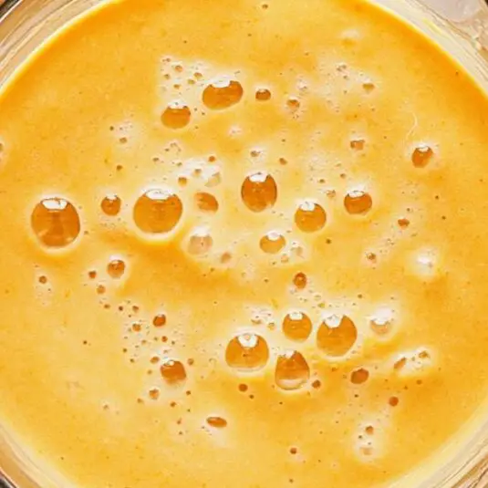 Blending tropical smoothie in a blender