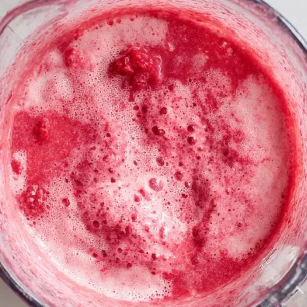 Blended raspberry lemonade smoothie in blender