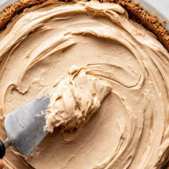 Filling the pie crust with peanut butter mixture