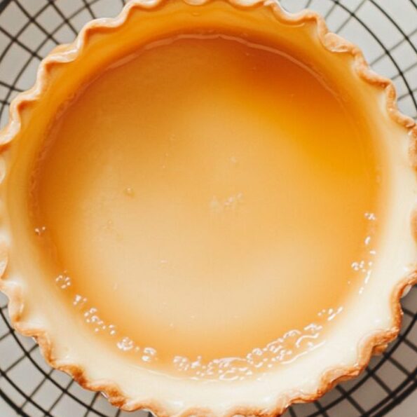Flan cooling on a wire rack at room temperature after baking.

