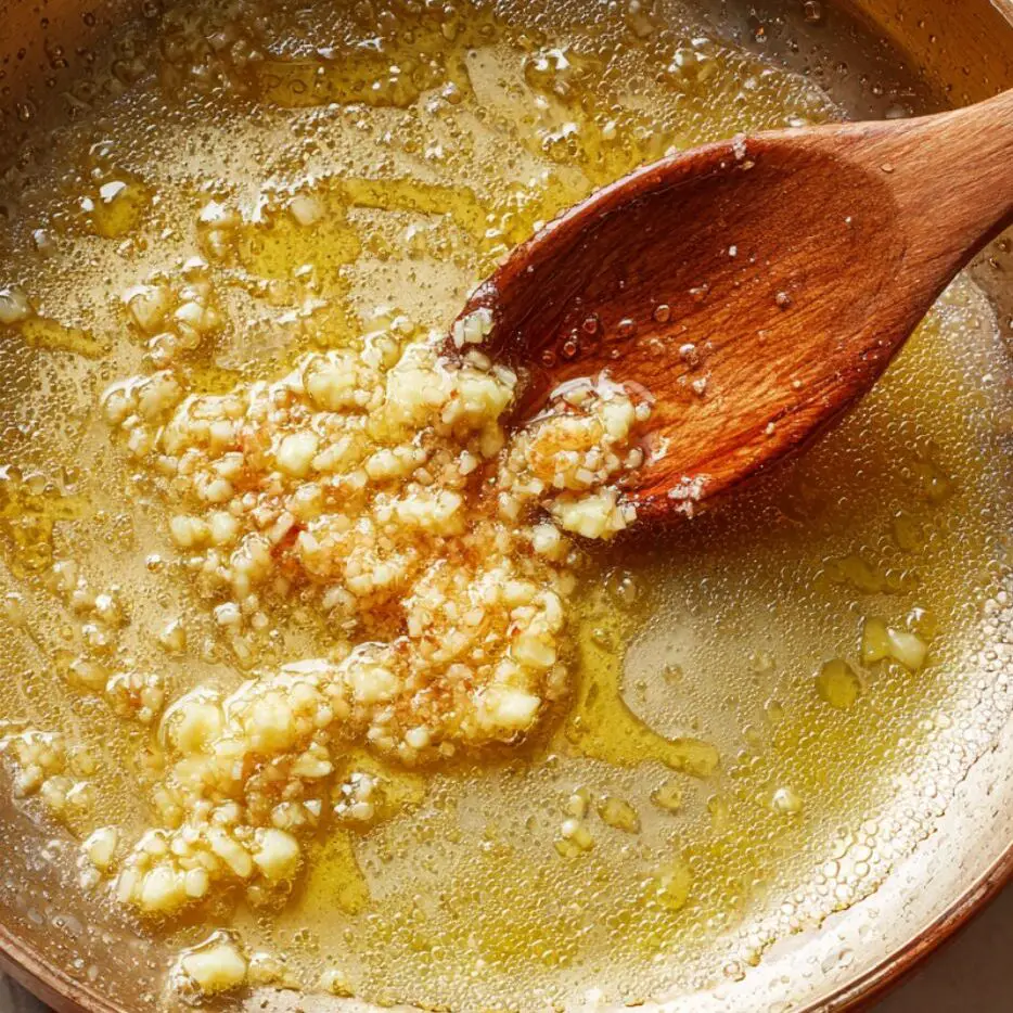 Butter and minced garlic melting together in a skillet to form the glaze.	