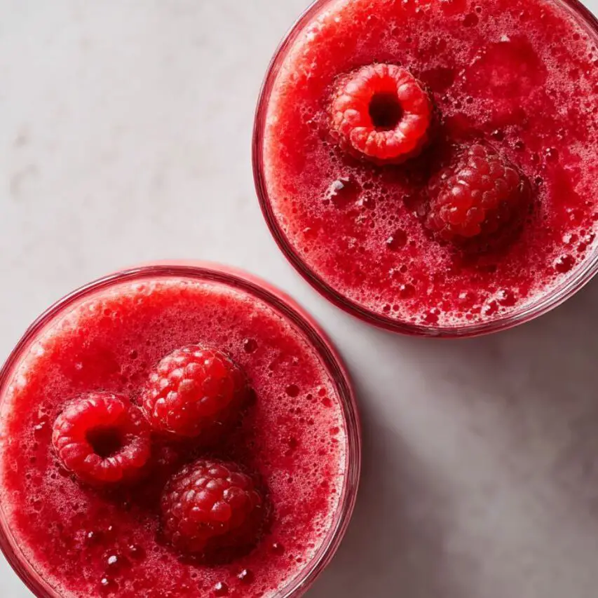 Raspberry lemonade smoothies served in glasses with garnish