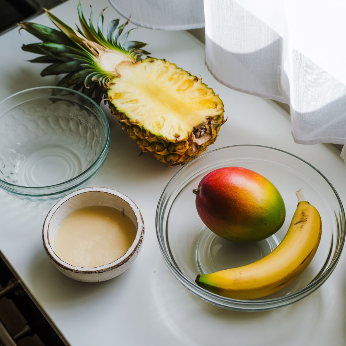 Fresh tropical smoothie recipe ingredients laid out on a counter