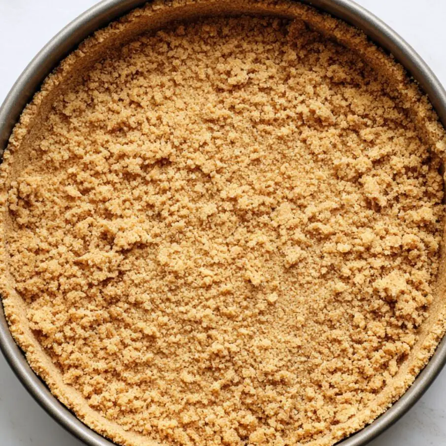 Graham cracker crust pressed into a springform pan