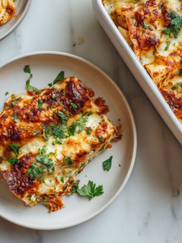 Overhead view of freshly baked seafood enchiladas recipe with golden cheese in a baking dish