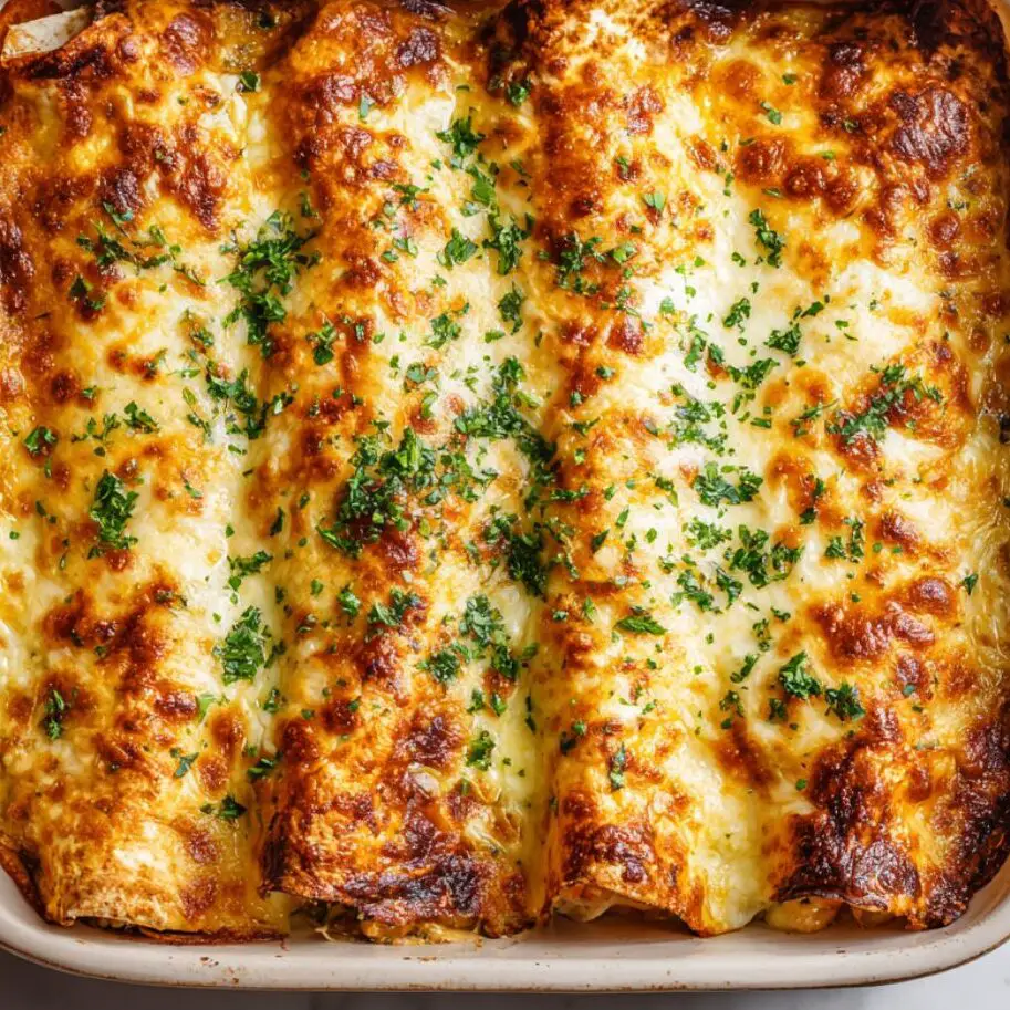 Overhead shot of baked seafood enchiladas with golden melted cheese

