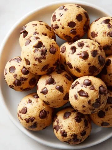 Close-up of homemade cookie dough bites recipe on a white kitchen counter