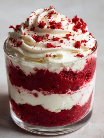 Homemade red velvet pudding recipe in a glass with cream cheese layers and whipped topping