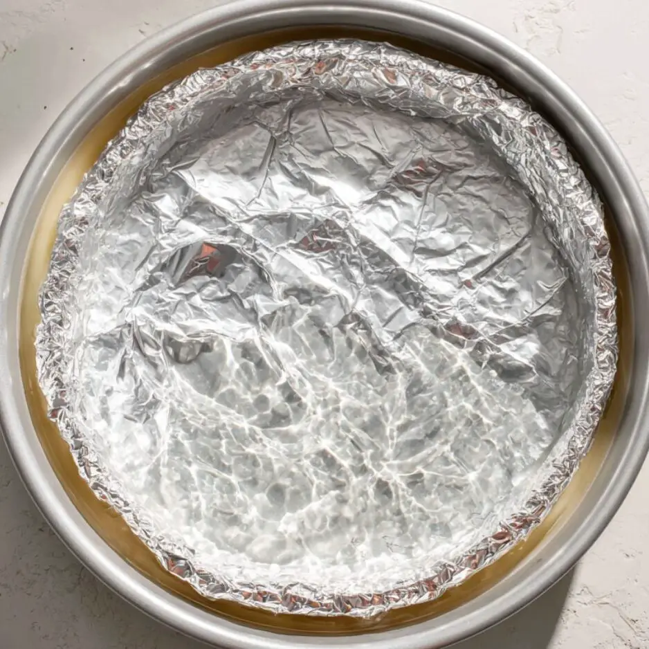 Flan mold in water bath inside oven