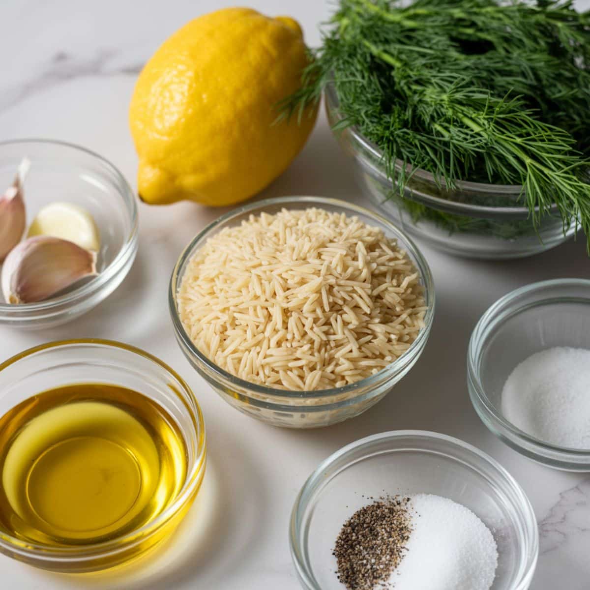 Ingredients for lemon dill rice recipe displayed on a white countertop.