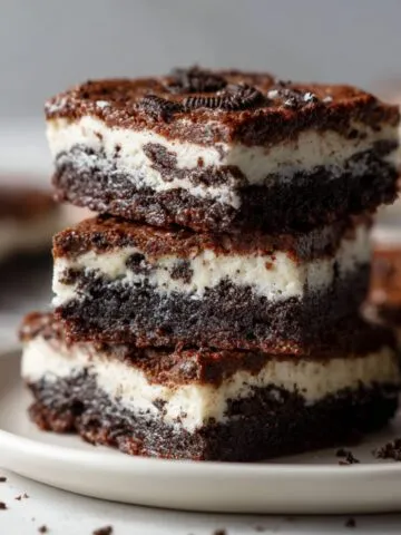Close-up of a stack of homemade Oreo cookie bars recipe on a white countertop