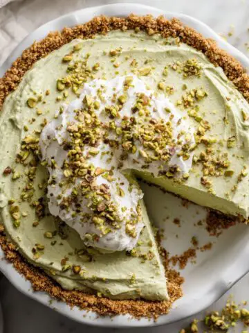 Overhead shot of a homemade pistachio pie recipe with whipped topping and crushed pistachios
