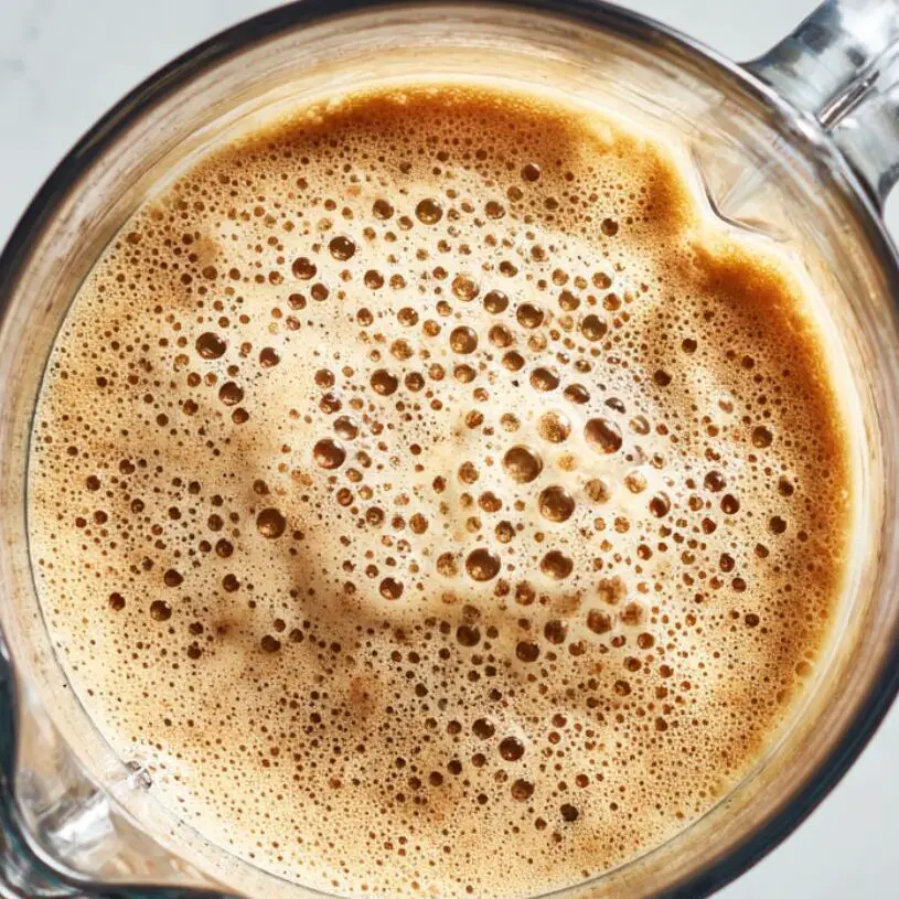 Banana coffee smoothie being blended to a creamy consistency