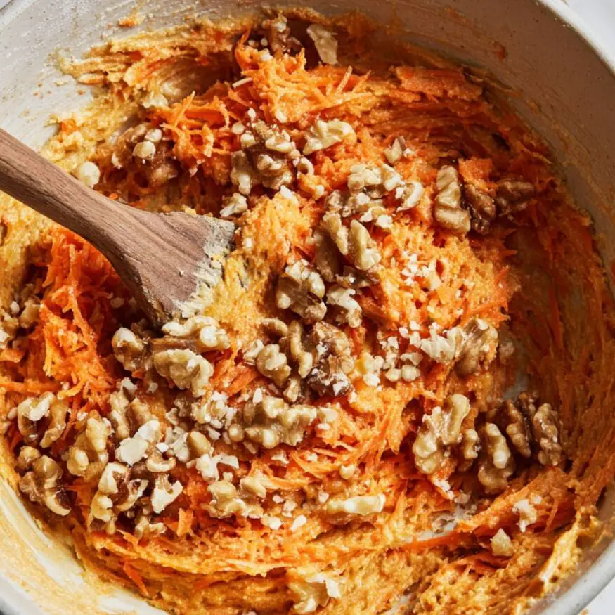 Carrot cake batter with grated carrots and walnuts