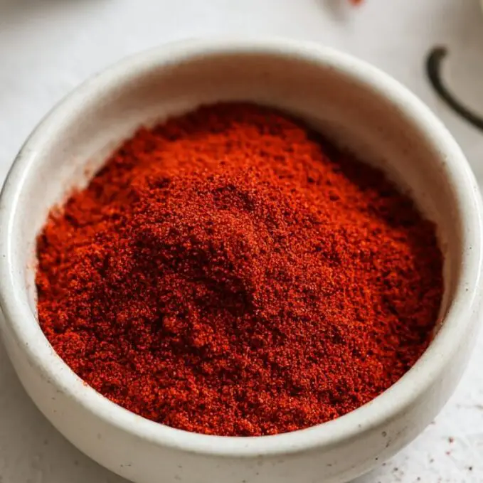 A bowl of spicy seasoning blend used for spicy cheese fries.
