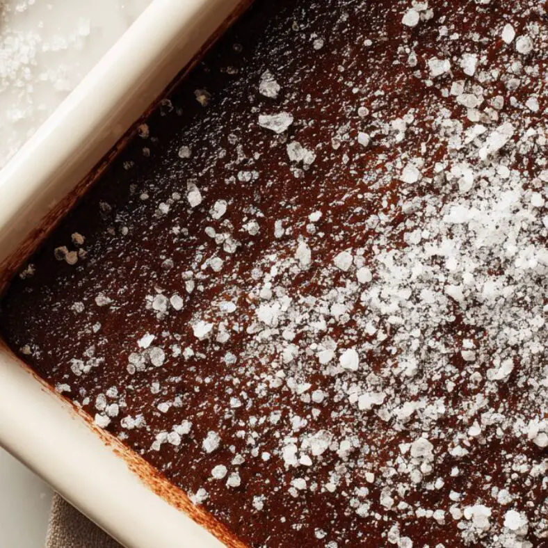 Sprinkling cocoa and sugar topping over cake batter