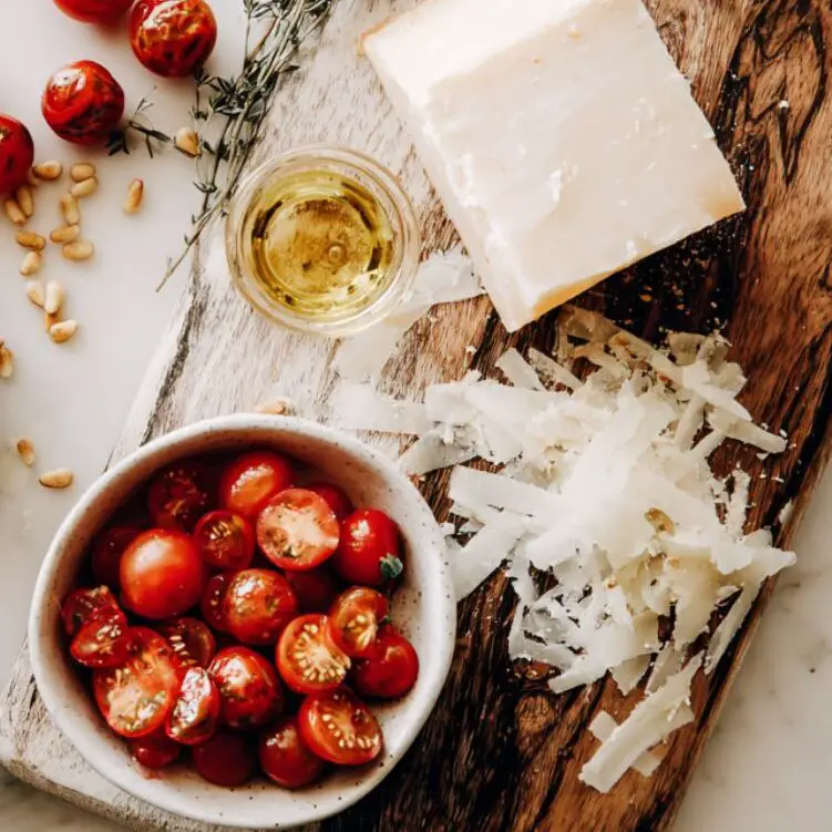 Toasted nuts, cherry tomatoes, and shaved parmesan prepared for salad