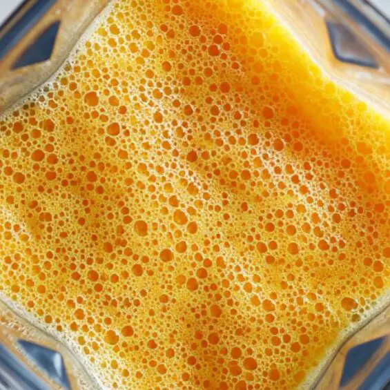 Papaya juice being blended in blender