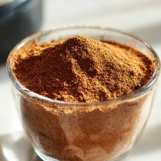 Cinnamon and spices next to shake ready for flavor adjustments