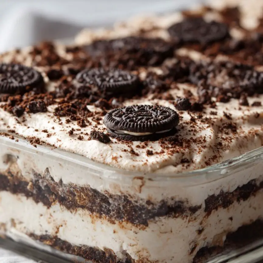 Oreo cake covered in plastic wrap, ready for refrigeration