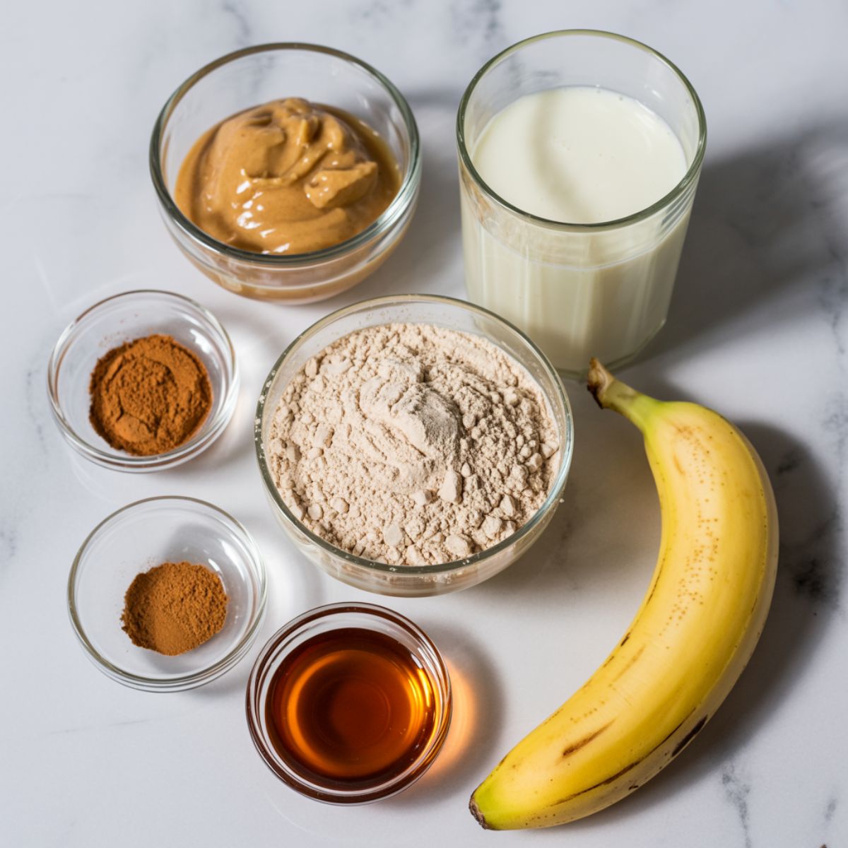 Ingredients for Vanilla Chai Protein Shake laid out on white counter