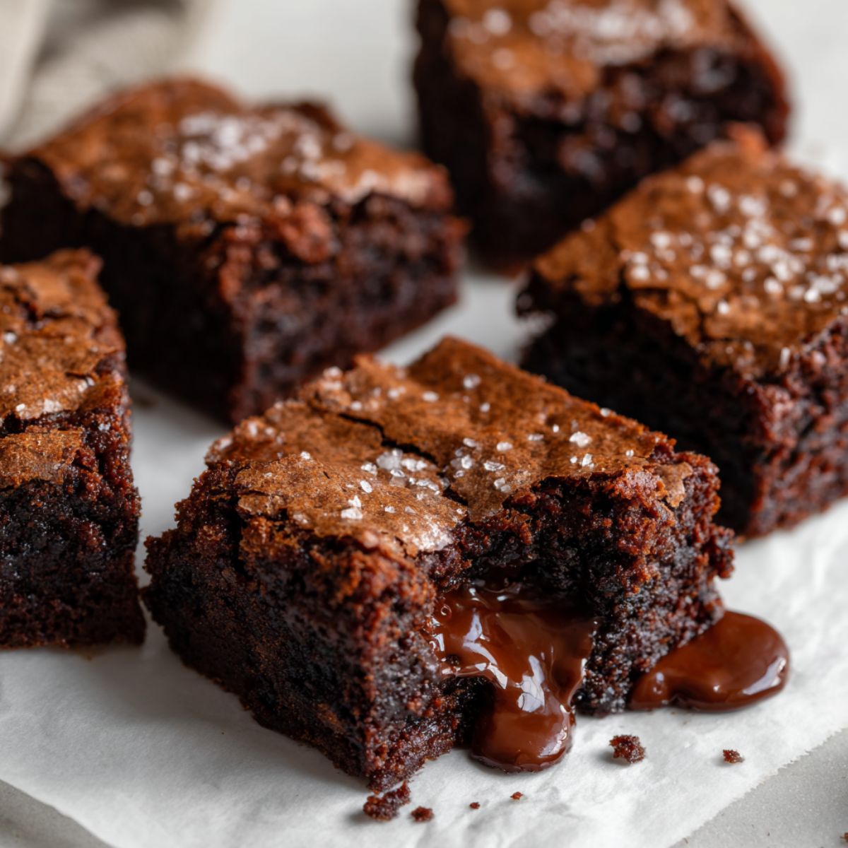 Homemade chocolate lava brownies recipe on a white marble counter with gooey molten centers, photographed from above in a natural homemade style.