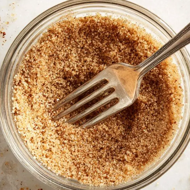 Cinnamon and sugar mixture in a small bowl on a white counter.