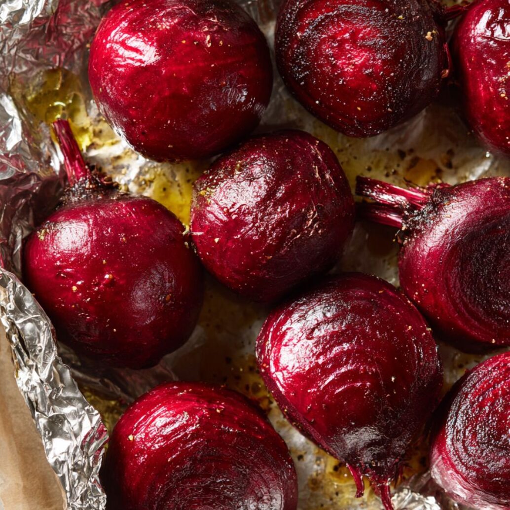 Overhead image of foil-wrapped beets on a baking sheet ready for roasting