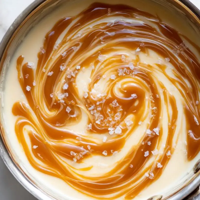 Caramel sauce being swirled into pudding base.