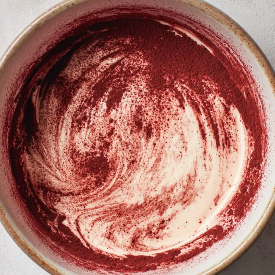 Whipped cream folded into the red velvet mixture.