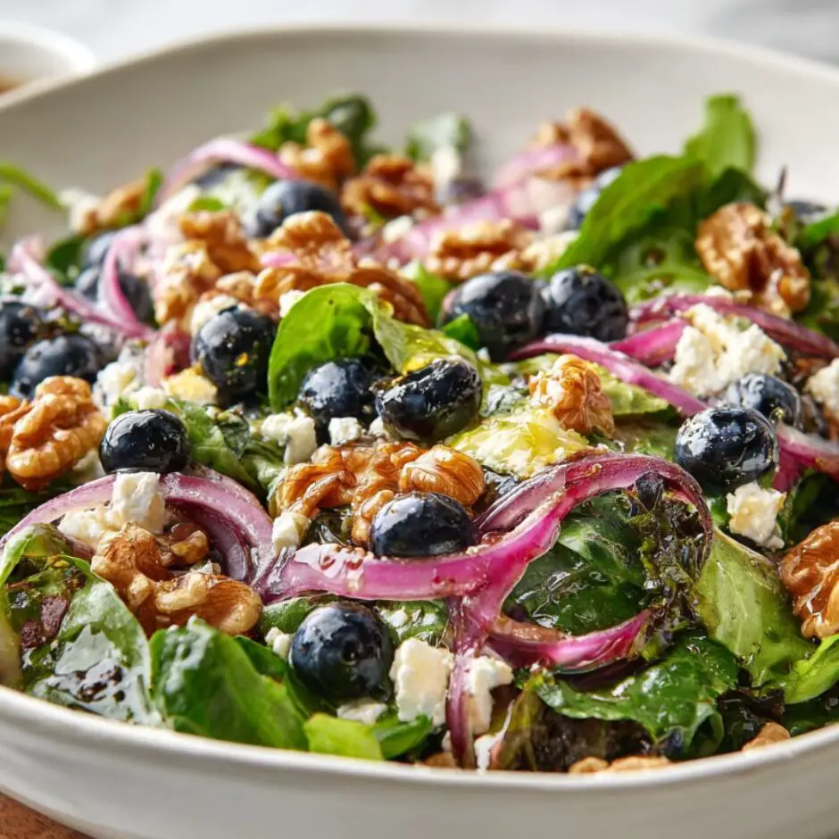 Blueberry walnut salad tossed with lemon dressing, ready to serve.
