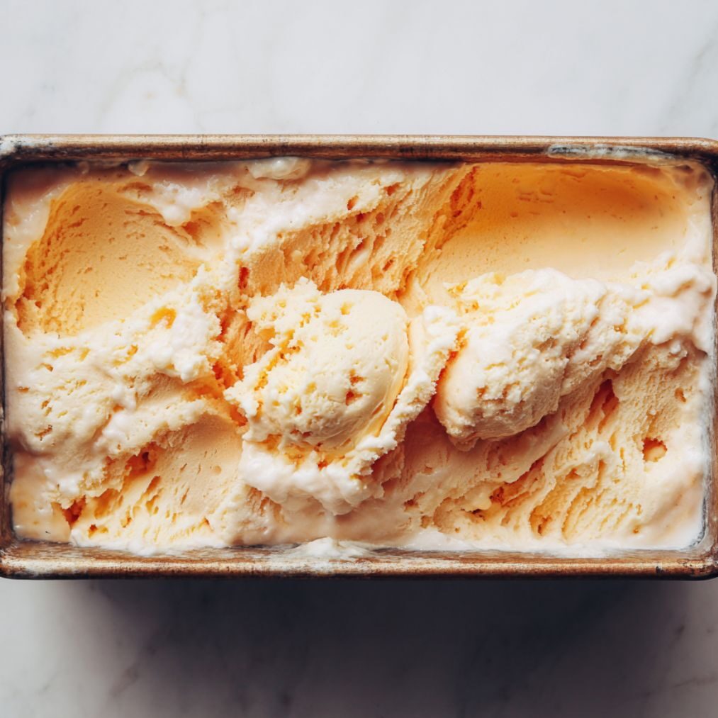 Pan of homemade peach ice cream ready for freezing